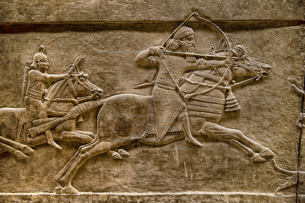 Assyrian relief sculpture panel of Ashurnasirpal lion hunting. From Nineveh North Palace, Iraq, 668-627 B.C. British Museum Assyrian Archaeological exhibit no ME 124876.